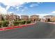 A gated community featuring well-maintained landscaping, sidewalks, and a secure entrance for residents at 6130 Sinks Canyon Ave, Las Vegas, NV 89130