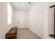 A well-lit entryway with tile floors, a wooden trunk, and two white doors at 6130 Sinks Canyon Ave, Las Vegas, NV 89130