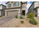 Charming two-story home with a two car garage and desert landscaping with a brick paver driveway at 6130 Sinks Canyon Ave, Las Vegas, NV 89130