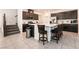 Modern kitchen with a large island, stainless steel appliances, and dark wood cabinetry at 6130 Sinks Canyon Ave, Las Vegas, NV 89130