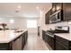 Well-equipped kitchen with quartz countertops, stainless appliances, and sleek, dark cabinetry at 6130 Sinks Canyon Ave, Las Vegas, NV 89130