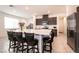 Bright kitchen boasts a large island with bar seating and stainless steel appliances at 6130 Sinks Canyon Ave, Las Vegas, NV 89130
