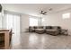 Bright and airy living room featuring tile floors, a ceiling fan, and sliding glass doors at 6130 Sinks Canyon Ave, Las Vegas, NV 89130