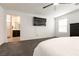 Bright main bedroom with carpet, ceiling fan, and view to en-suite bath and walk-in closet at 6130 Sinks Canyon Ave, Las Vegas, NV 89130