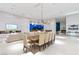 Spacious dining area featuring modern light fixtures and seamless access to outdoor entertainment space at 63 Midnight Sky Dr, Las Vegas, NV 89135