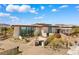 Modern home with clean lines, desert landscaping, and expansive windows that enhance curb appeal at 63 Midnight Sky Dr, Las Vegas, NV 89135