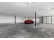 Spacious garage featuring an enclosed room and a red car parked inside at 63 Midnight Sky Dr, Las Vegas, NV 89135