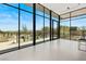 Bright and airy living room showcasing floor-to-ceiling windows with stunning views of the outdoor landscape at 63 Midnight Sky Dr, Las Vegas, NV 89135
