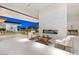 Modern living space with fireplace and sliding glass doors leading to a relaxing outdoor area by the pool at 63 Midnight Sky Dr, Las Vegas, NV 89135