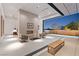 Stylish living room with fireplace and seamless access to the outdoor living space and pool at 63 Midnight Sky Dr, Las Vegas, NV 89135