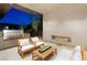 This outdoor kitchen and living area features a built-in grill and fireplace at 63 Midnight Sky Dr, Las Vegas, NV 89135