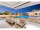 Outdoor living space with comfortable seating and a beautiful view of the pool at 63 Midnight Sky Dr, Las Vegas, NV 89135