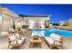 Inviting outdoor pool area with comfortable seating, perfect for relaxation and entertaining in style at 63 Midnight Sky Dr, Las Vegas, NV 89135