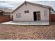 View of the rear exterior with a patio and sliding glass door, and rock landscaping at 6608 Elk Creek Ln, Las Vegas, NV 89156