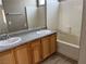 Bright bathroom featuring a double vanity, tub, and neutral color palette at 6608 Elk Creek Ln, Las Vegas, NV 89156