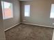 Bedroom with neutral walls, plush brown carpet, and natural light from windows at 6608 Elk Creek Ln, Las Vegas, NV 89156