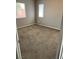 Empty bedroom with neutral walls, plush brown carpet, and natural light from windows at 6608 Elk Creek Ln, Las Vegas, NV 89156