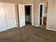 Bedroom with carpet and closets with hallway access to laundry and bathroom at 6608 Elk Creek Ln, Las Vegas, NV 89156