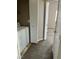 Hallway view leading to laundry area and carpeted bedroom with open door at 6608 Elk Creek Ln, Las Vegas, NV 89156