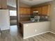 Efficient kitchen layout with wood cabinets, essential appliances, and a breakfast bar for casual dining at 6608 Elk Creek Ln, Las Vegas, NV 89156