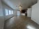 Bright living room with tile flooring, ceiling fan, and natural light from the large windows at 6615 Montezuma Castle Ln, North Las Vegas, NV 89084