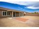 Spacious backyard with a covered patio and gravel landscaping at 6630 Windy Palm St, North Las Vegas, NV 89086