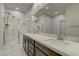 Bathroom features a double sink vanity, glass shower, and modern fixtures at 6630 Windy Palm St, North Las Vegas, NV 89086