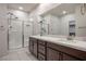Bright bathroom featuring a glass shower, double vanity and neutral color palette at 6630 Windy Palm St, North Las Vegas, NV 89086