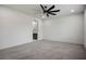 Spacious bedroom features a modern ceiling fan and plush gray carpet at 6630 Windy Palm St, North Las Vegas, NV 89086