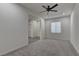 Carpeted bedroom with a ceiling fan, window and access to other rooms at 6630 Windy Palm St, North Las Vegas, NV 89086