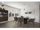 Modern dining room with wood floors, stylish lighting, and bright windows at 6630 Windy Palm St, North Las Vegas, NV 89086