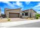 Single-story home featuring a two-car garage, desert landscaping, and gated front entry at 6630 Windy Palm St, North Las Vegas, NV 89086