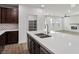 Bright kitchen features a large quartz island and stainless steel appliances in an open concept layout at 6630 Windy Palm St, North Las Vegas, NV 89086