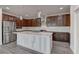 Well-lit kitchen featuring stainless steel appliances, modern lighting, and beautiful tile backsplash at 6630 Windy Palm St, North Las Vegas, NV 89086