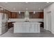 Well-lit kitchen with stainless steel appliances, custom cabinets, and a center island at 6630 Windy Palm St, North Las Vegas, NV 89086