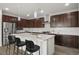 Modern kitchen featuring stainless steel appliances, an island with seating, and tile backsplash at 6630 Windy Palm St, North Las Vegas, NV 89086