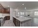 Open concept kitchen featuring a center island and a view of the spacious living room at 6630 Windy Palm St, North Las Vegas, NV 89086