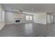 Spacious living room featuring wood flooring, a modern fireplace, and bright, natural light at 6630 Windy Palm St, North Las Vegas, NV 89086