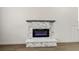 Close-up of the electric fireplace with stacked stone and marble-look trim in the open-concept living room at 6630 Windy Palm St, North Las Vegas, NV 89086