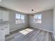 Sunlit dining area with modern light fixture and views of the backyard at 6631 S Parkwood Ct, Pahrump, NV 89061