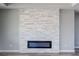 Modern electric fireplace surrounded by a decorative stone wall at 6631 S Parkwood Ct, Pahrump, NV 89061