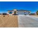 Charming single-story home with a spacious driveway and a xeriscaped front yard at 6631 S Parkwood Ct, Pahrump, NV 89061