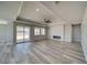 Spacious living room with wood-look floors and a modern fireplace feature at 6631 S Parkwood Ct, Pahrump, NV 89061