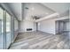 Bright living room featuring stylish fireplace, ceiling fan and sliding glass doors at 6631 S Parkwood Ct, Pahrump, NV 89061