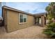 Backyard showcasing desert landscaping, exterior of home and covered patio at 6925 Cuddy Falls Pl, North Las Vegas, NV 89084