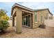 Inviting backyard featuring a covered patio, desert landscaping and privacy wall at 6925 Cuddy Falls Pl, North Las Vegas, NV 89084