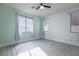 Spacious bedroom featuring stylish ceiling fan, wood-look floors, and light green accent wall at 6925 Cuddy Falls Pl, North Las Vegas, NV 89084