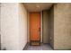 Inviting front entryway with a vibrant orange door and a 'Welcome' mat at 6925 Cuddy Falls Pl, North Las Vegas, NV 89084