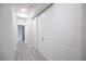 Bright hallway featuring modern flooring and closet storage at 6925 Cuddy Falls Pl, North Las Vegas, NV 89084