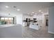 Open-concept kitchen with white cabinets, stainless steel appliances, and a center island at 6925 Cuddy Falls Pl, North Las Vegas, NV 89084